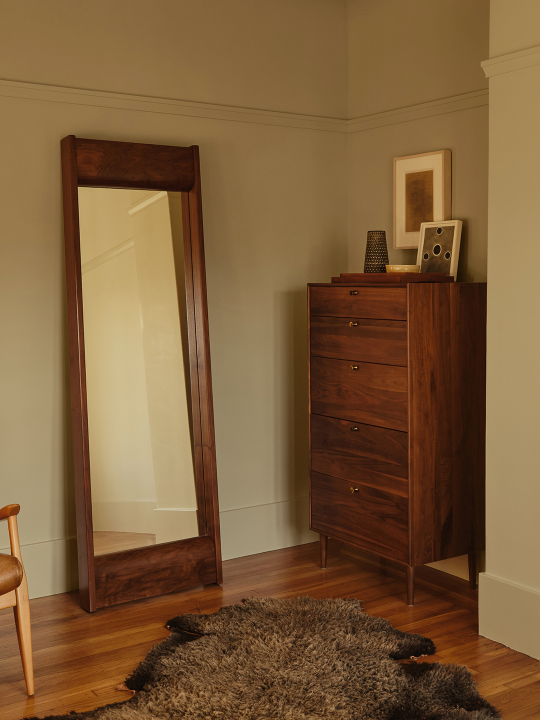wood mirror leaning on wall