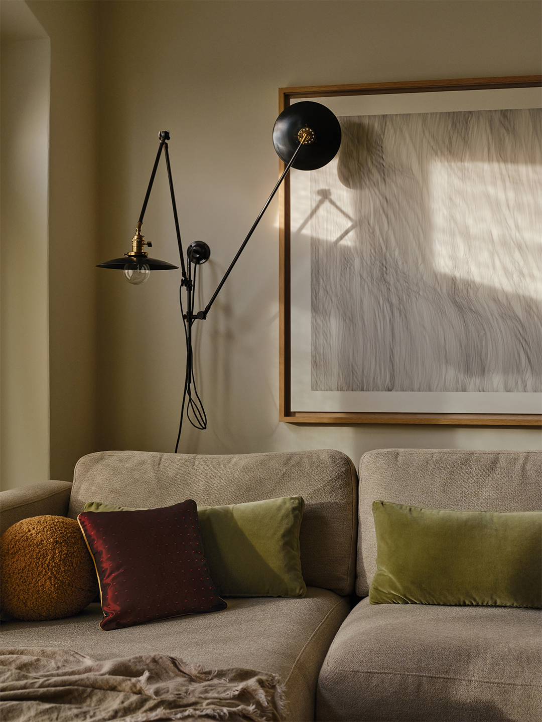 neutral sofa with articulating sconce above