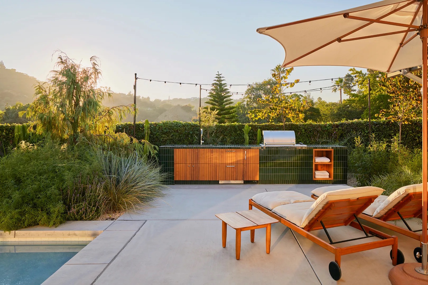 backyard with lounge chairs, umbrella, and tiled bar