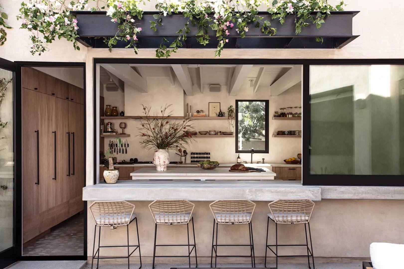 outdoor bar area with window into kitchen