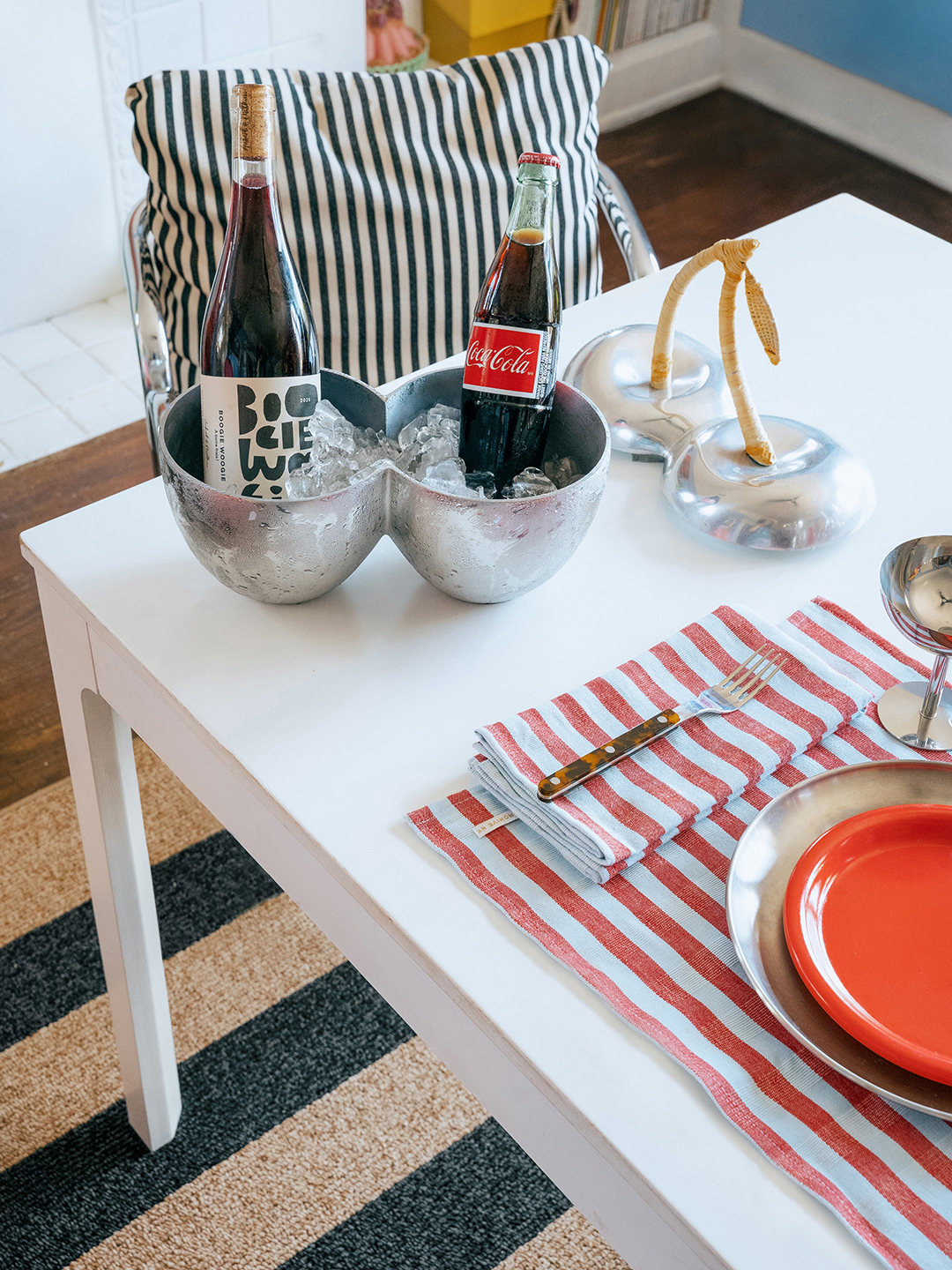 Table set with metal bowls of ice with wine and coke.