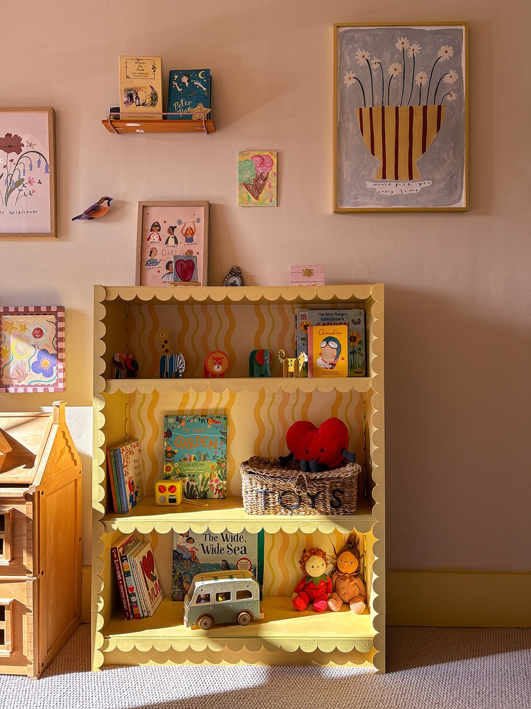 pink room with yellow bookcase