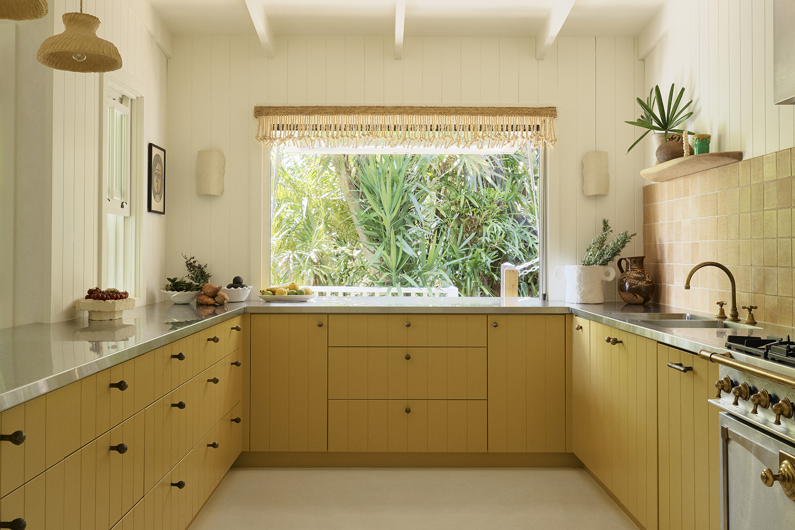 yellow kitchen with stainless-steel countertops