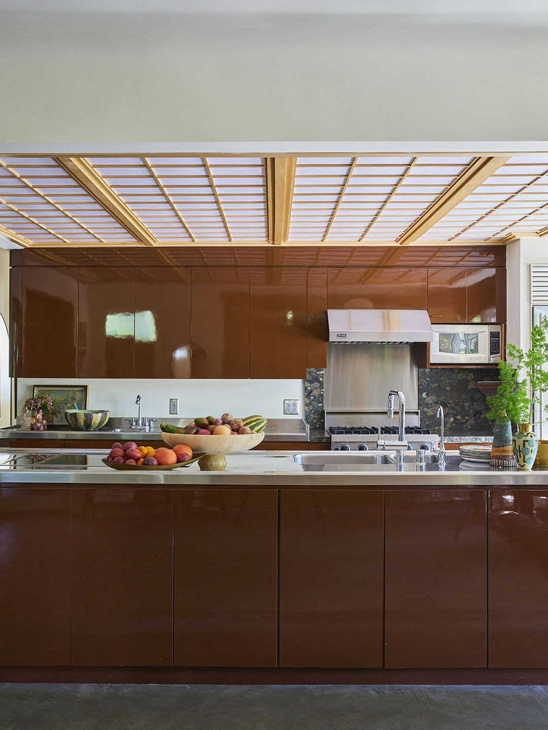 glossy red-brown kitchen with stainless steel countertops