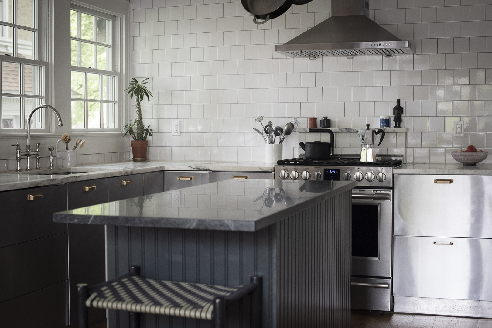 stainless steel kitchen with subway tile backsplash