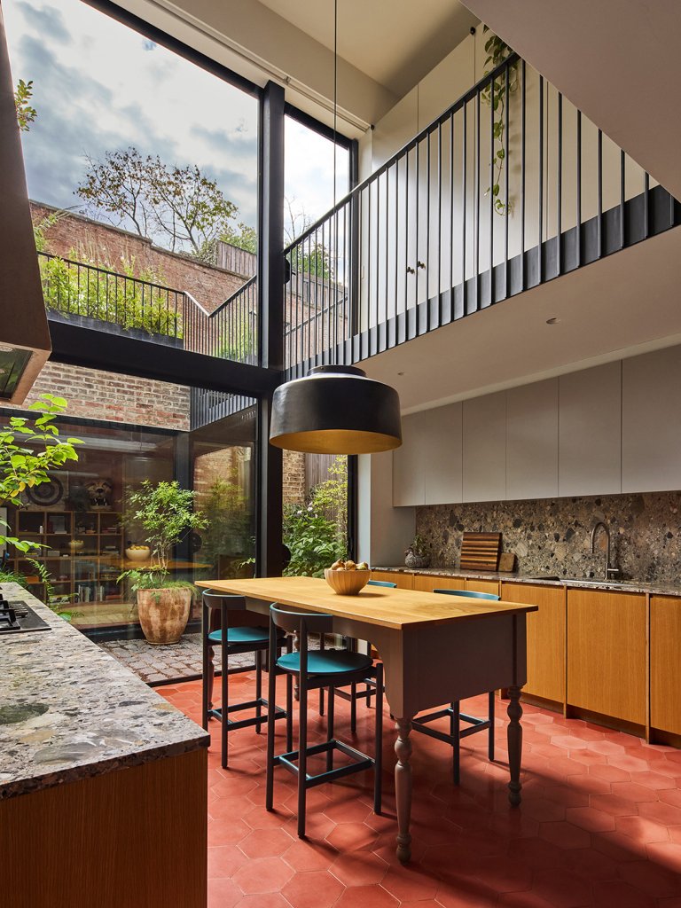 kitchen with terracotta tile and double height ceiling