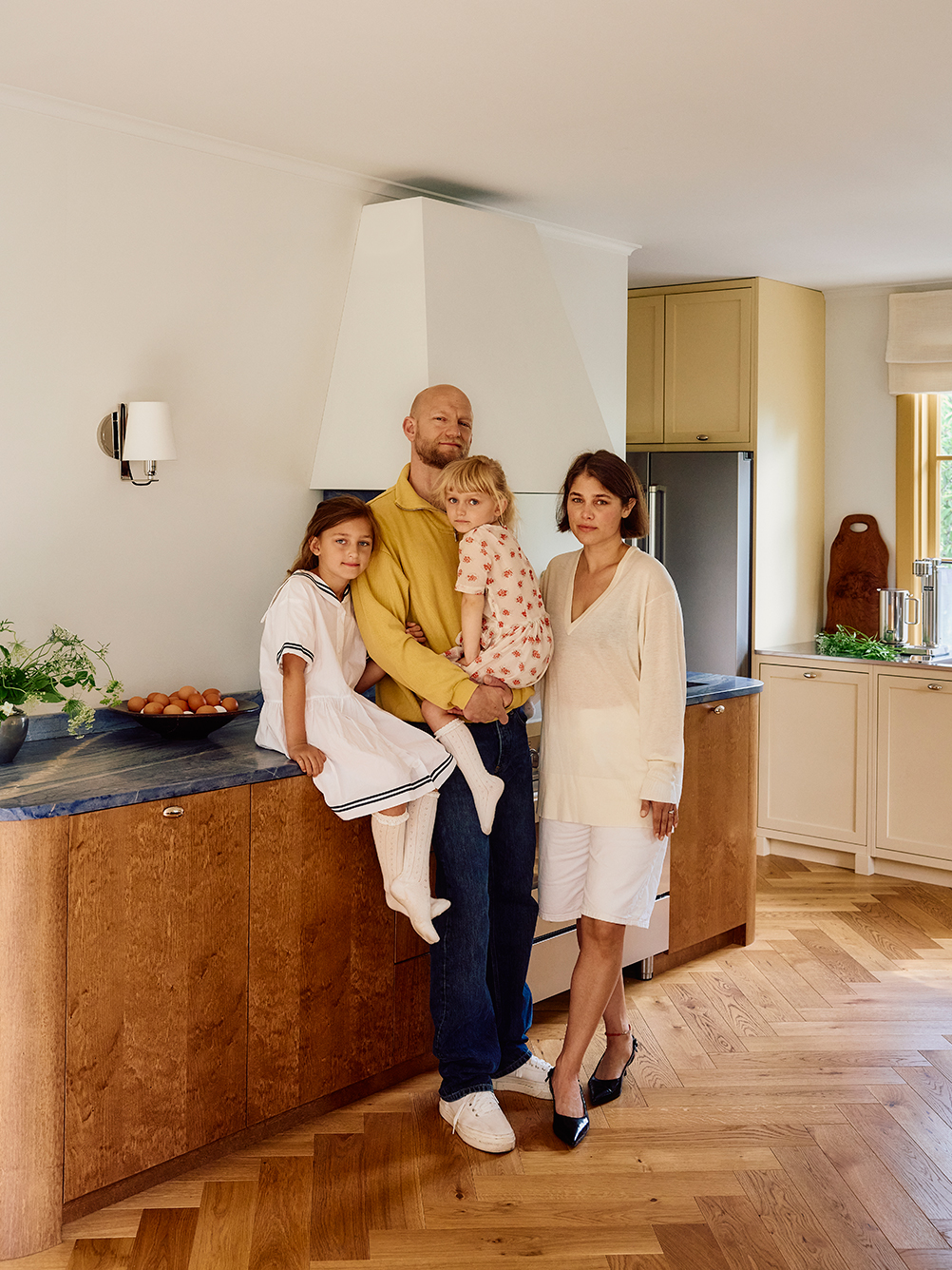family in a white and wood kitchen