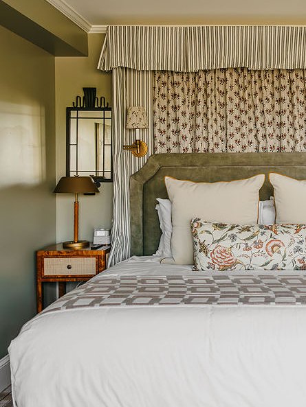bed with side table and fabric above