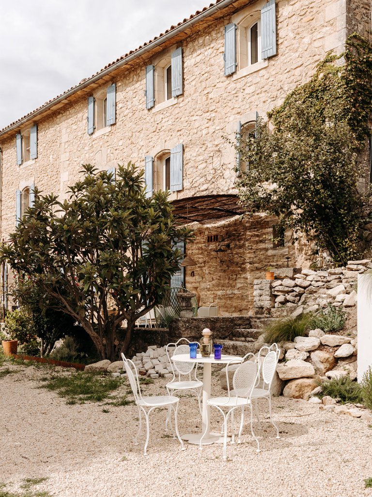 outside of a stone house with blue shutters