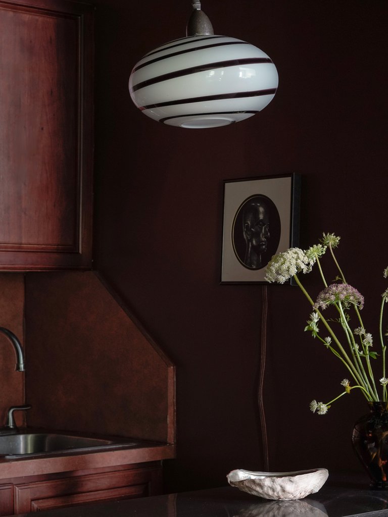 dark brown kitchen with glass pendant