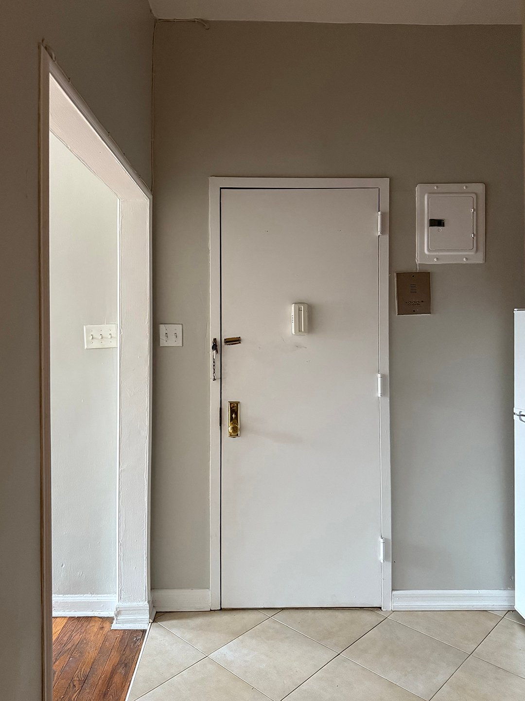 white and grey door with tile floor
