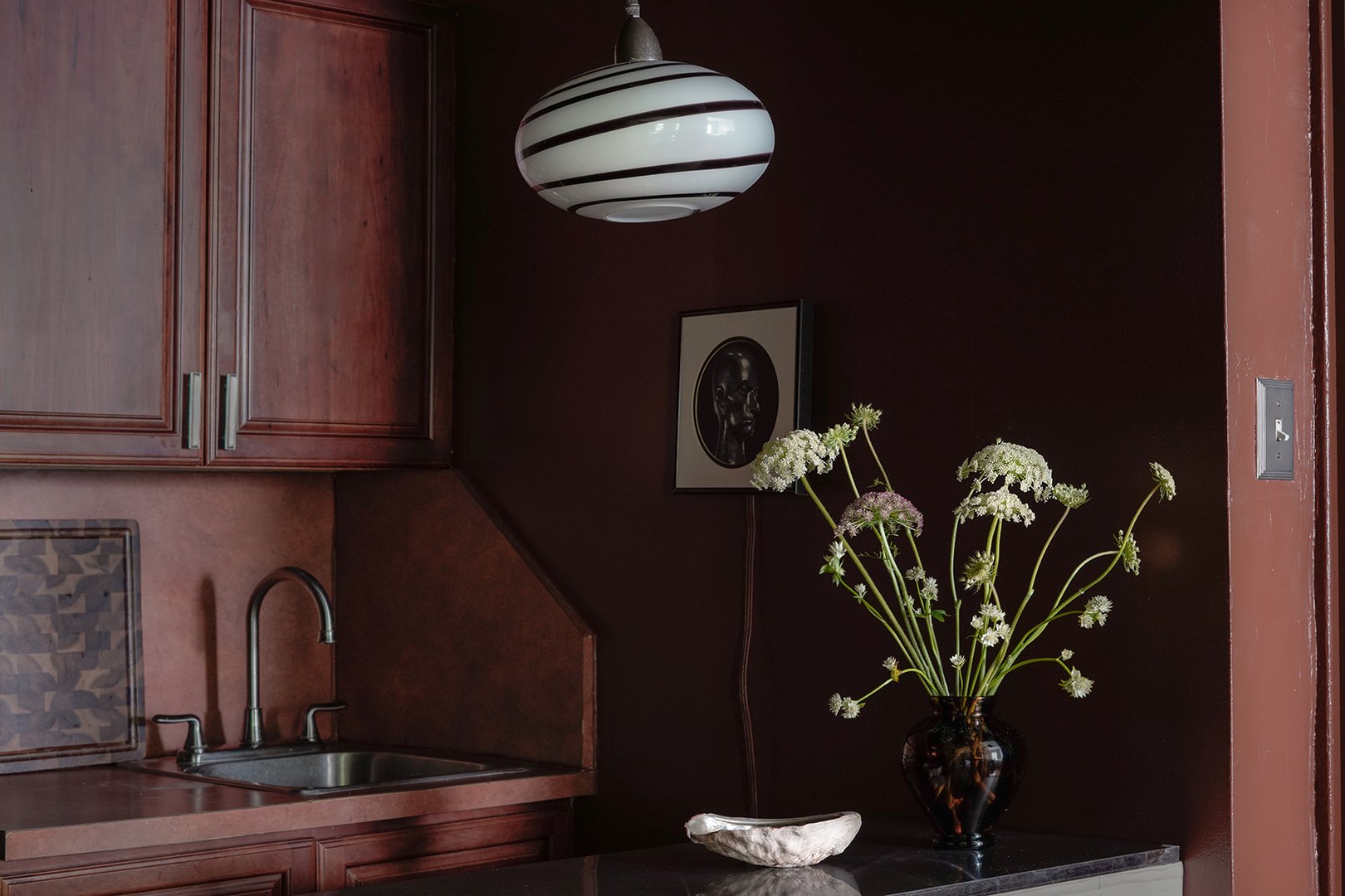 dark brown kitchen with matching walls and cabinets