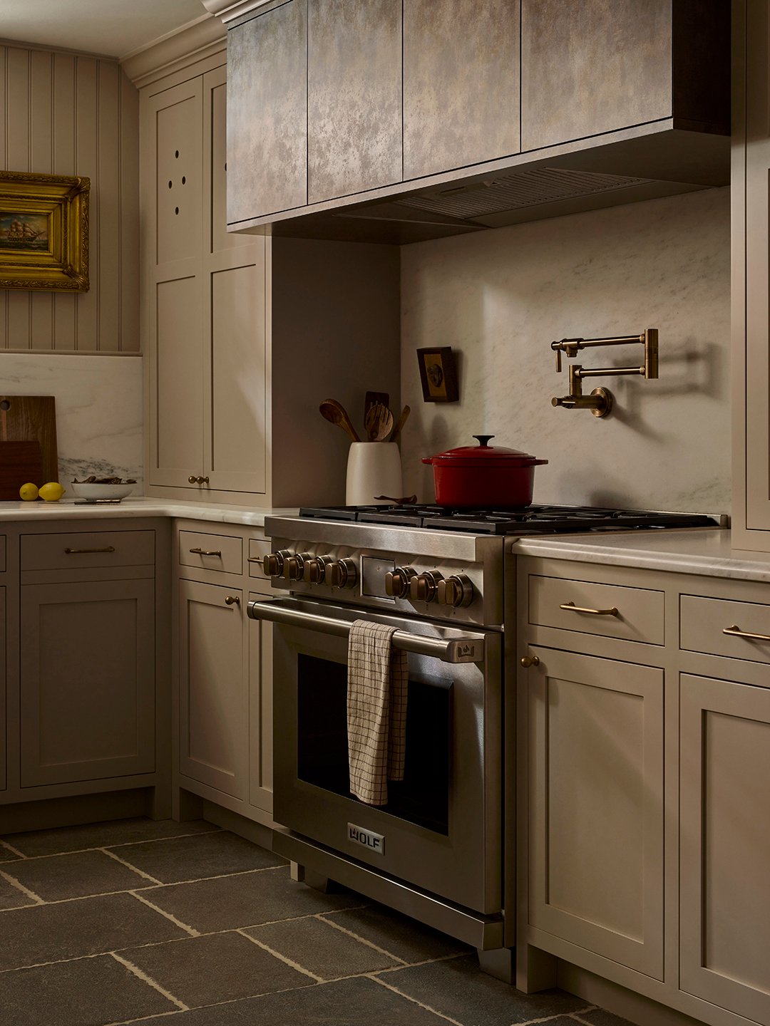 kitchen with cream cabinets and metal hood