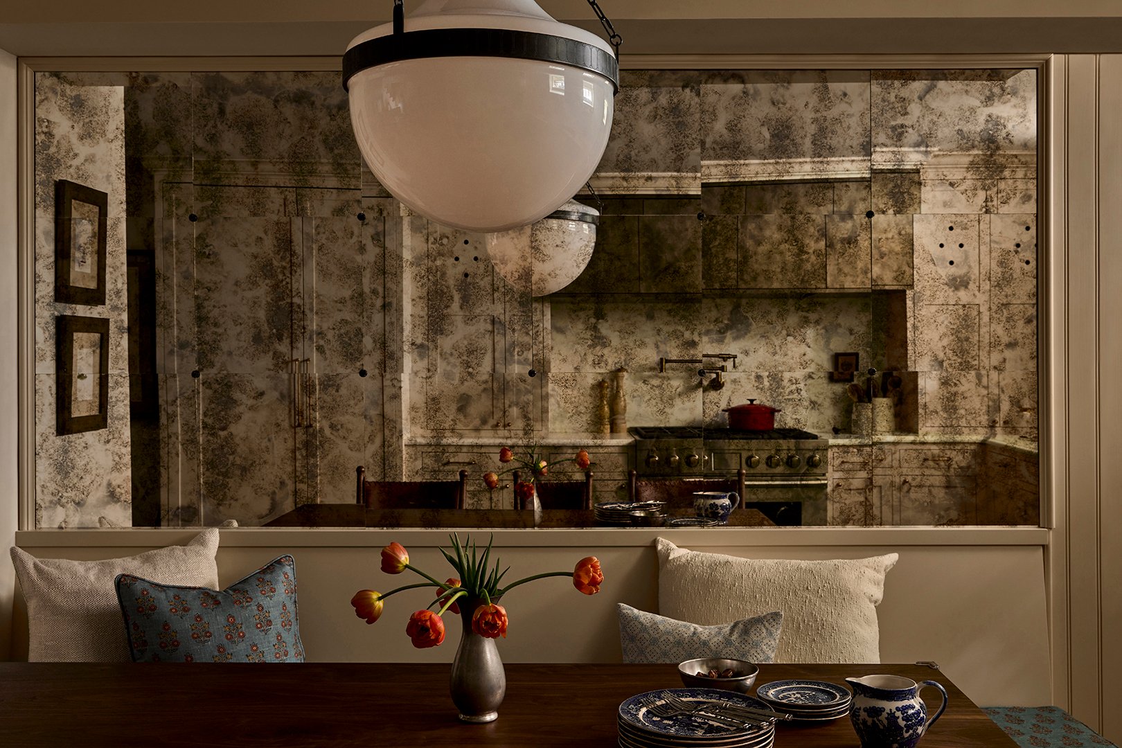 large patina-ed mirror above dining table