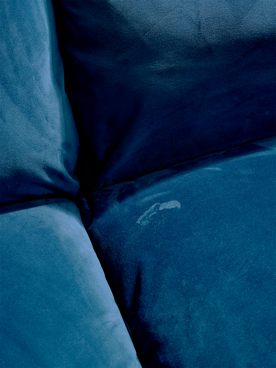 Gif of blue velvet sofa detail showing hand cleaning. 