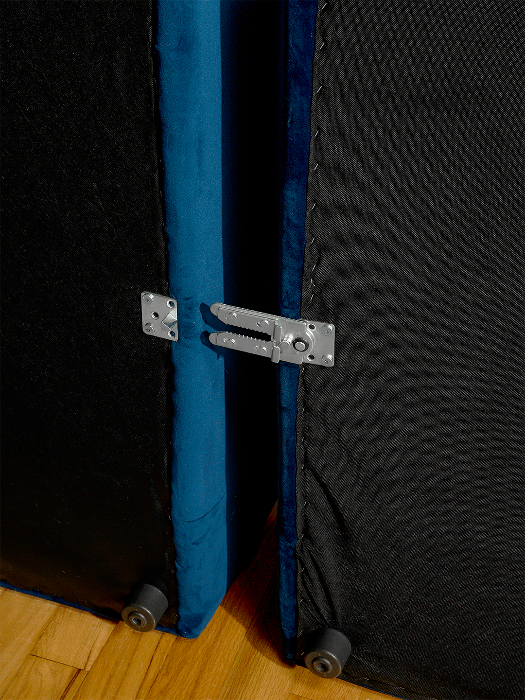 Blue velvet sectional sofa detail of parts clicking together.