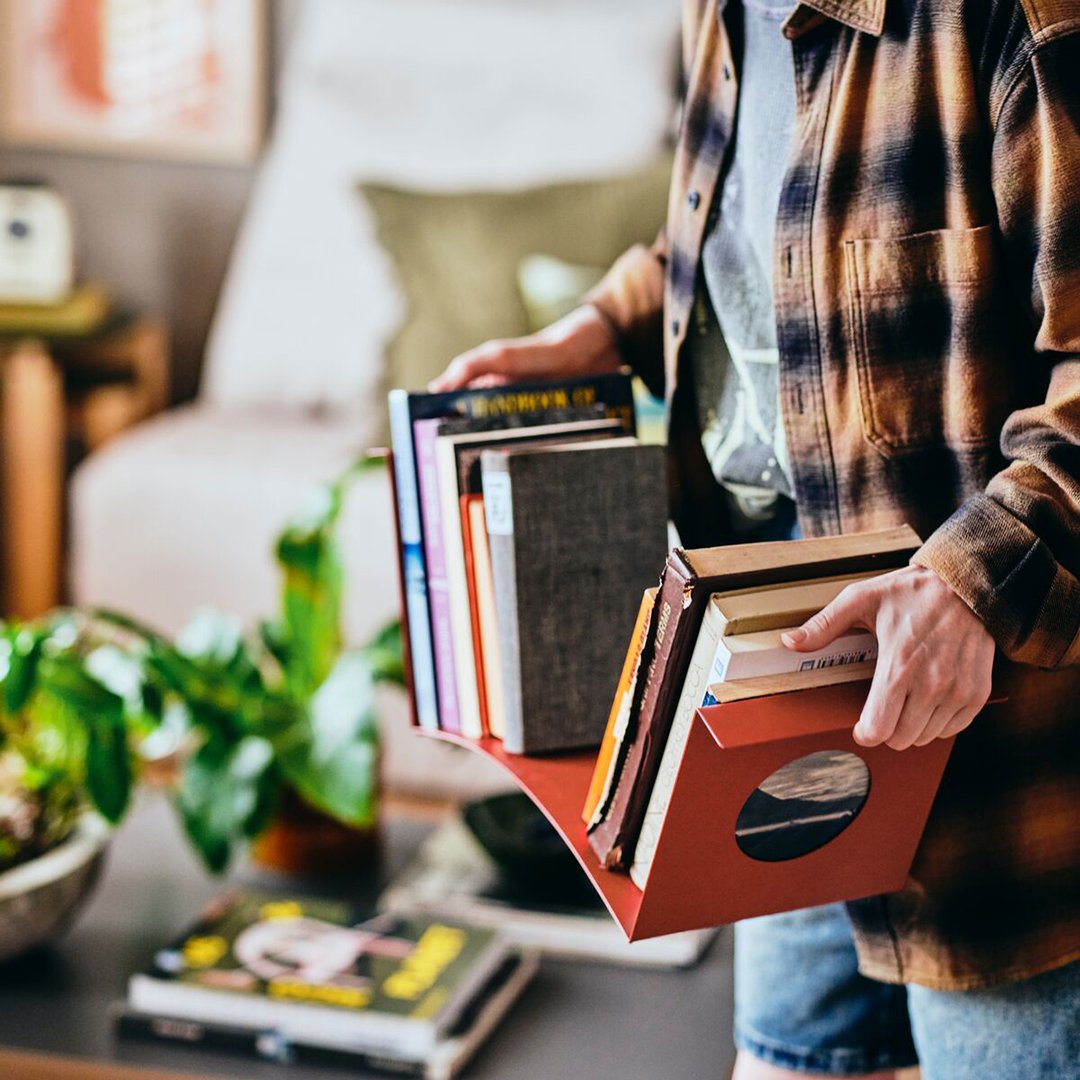 person carrying bookshelf