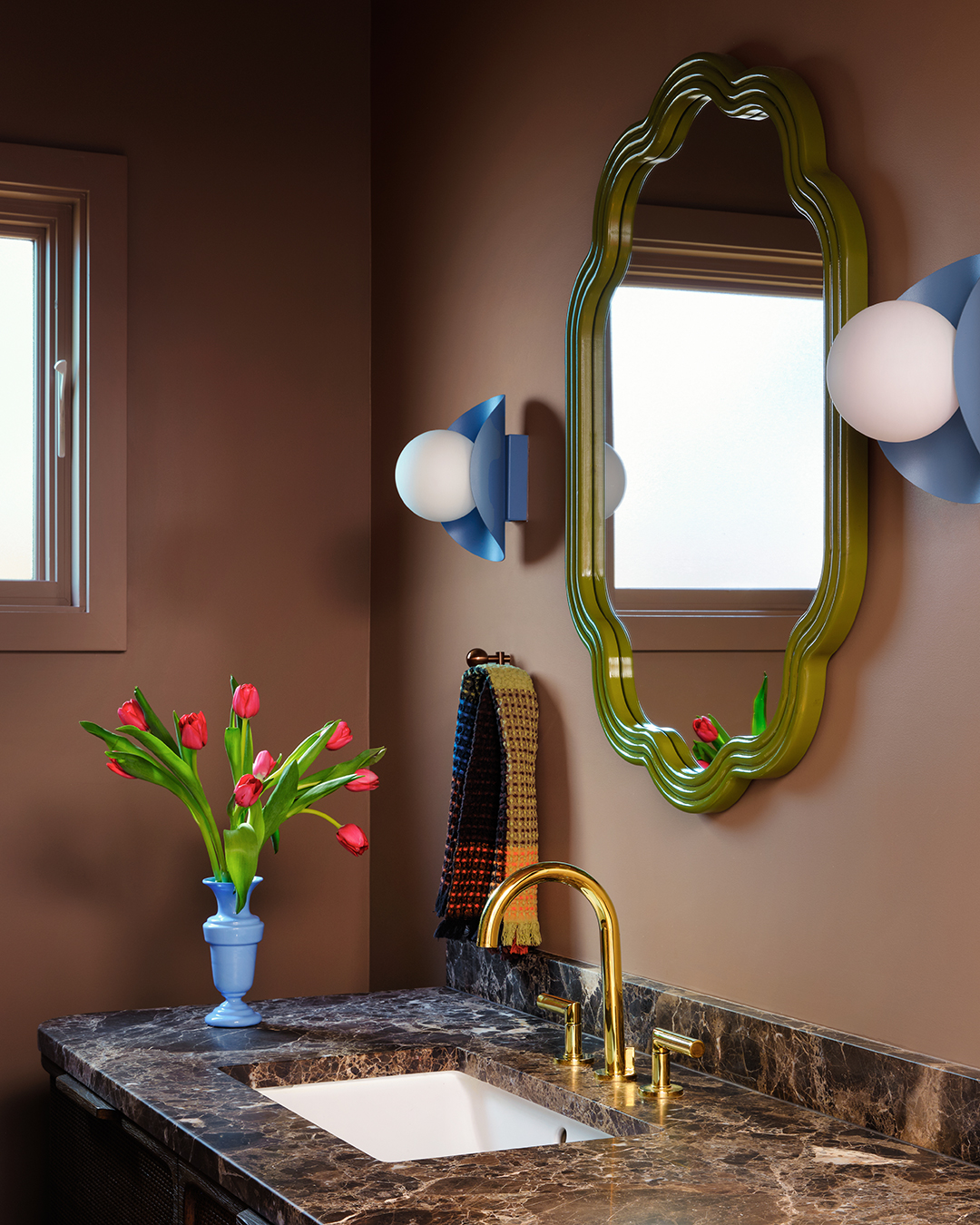 brown bathroom with green mirror