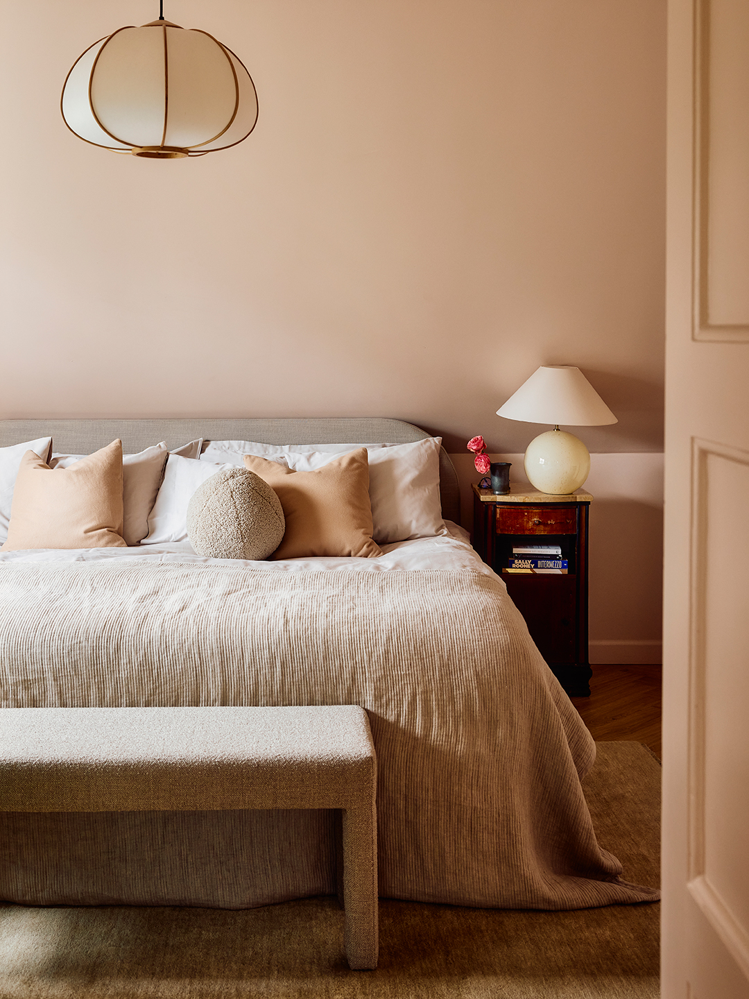 large bedroom with pale pink walls