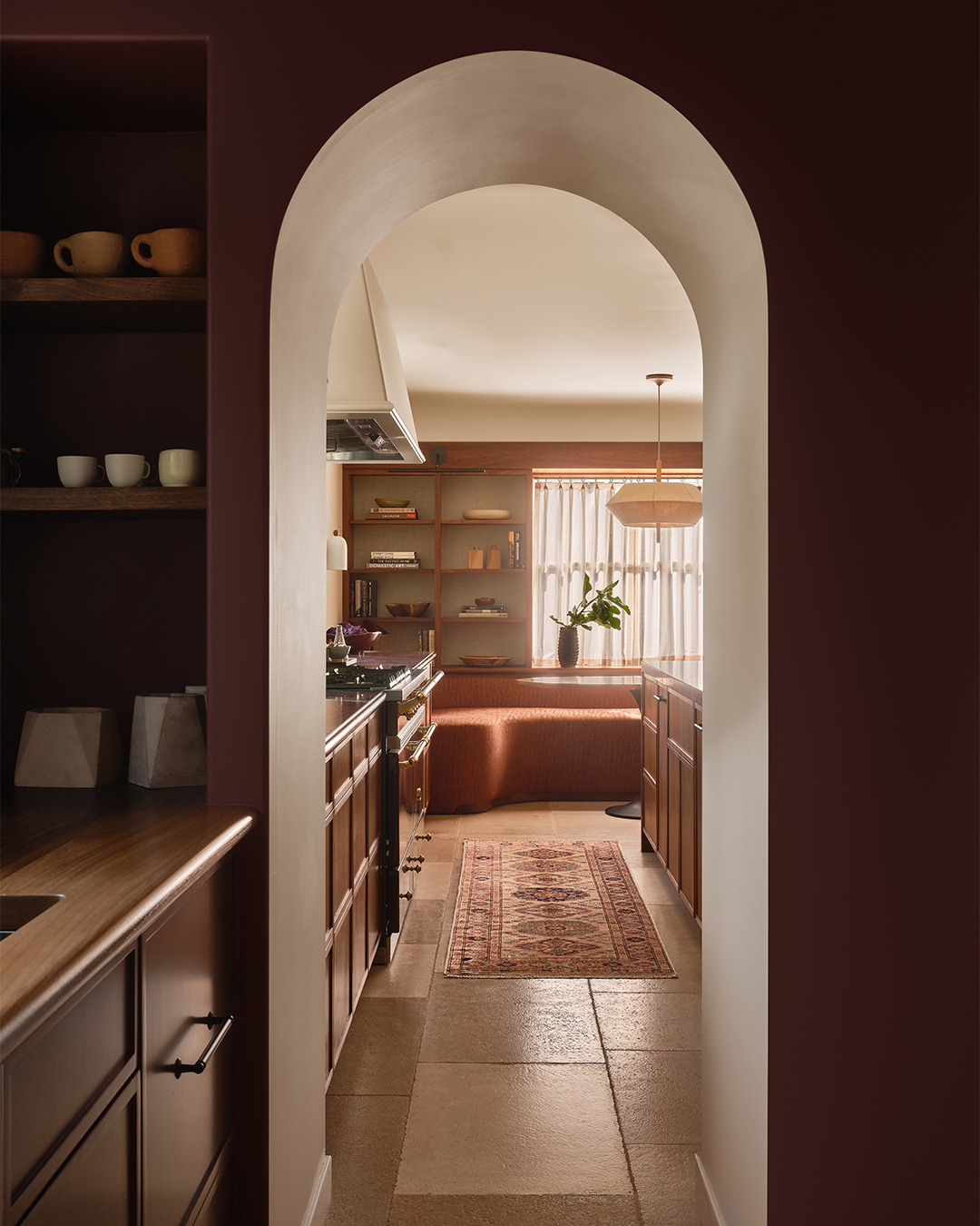maroon pantry and arched view into kitchen