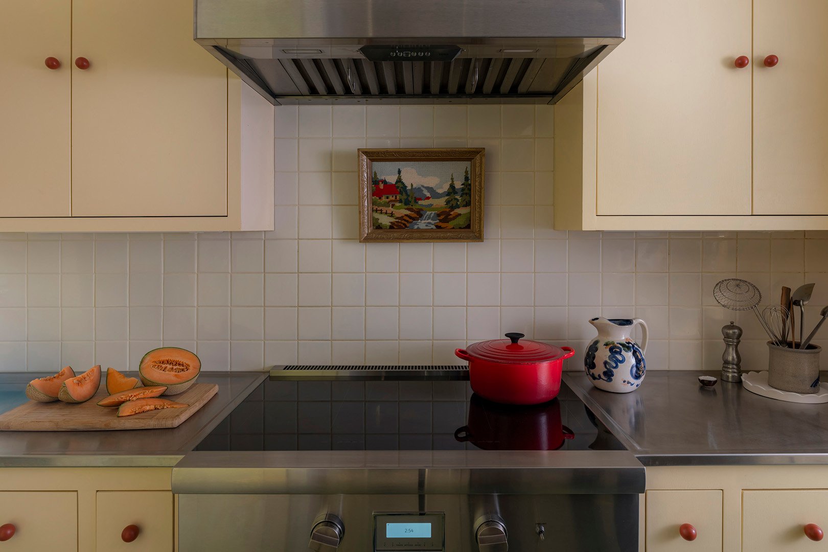 kitchen with white tiled backsplash above stove