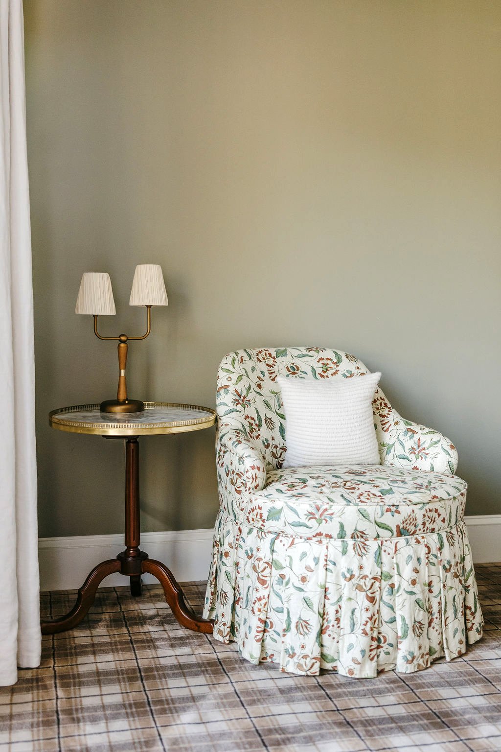 corner of room with side table and floral chair