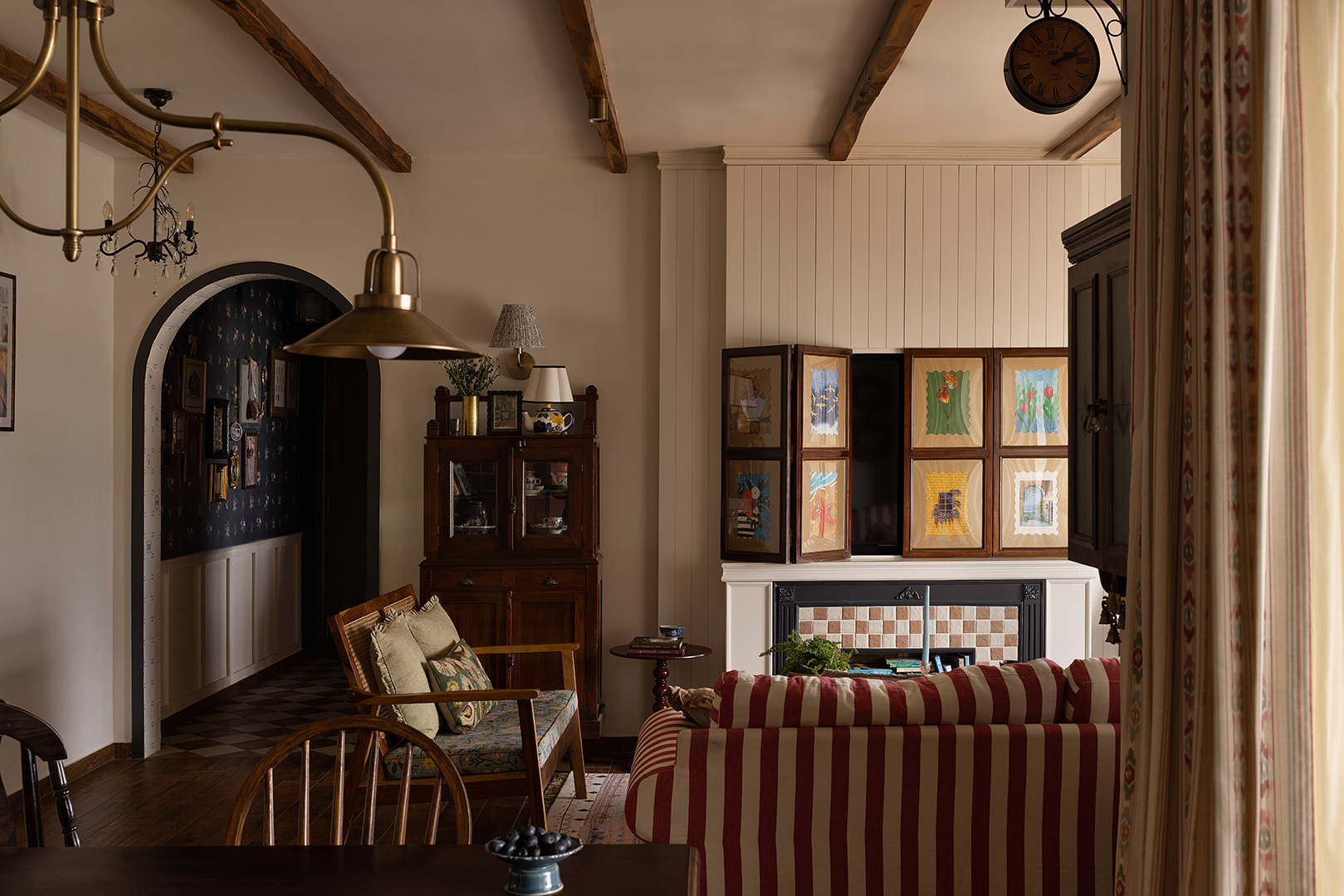 living room with hidden tv and striped sofa