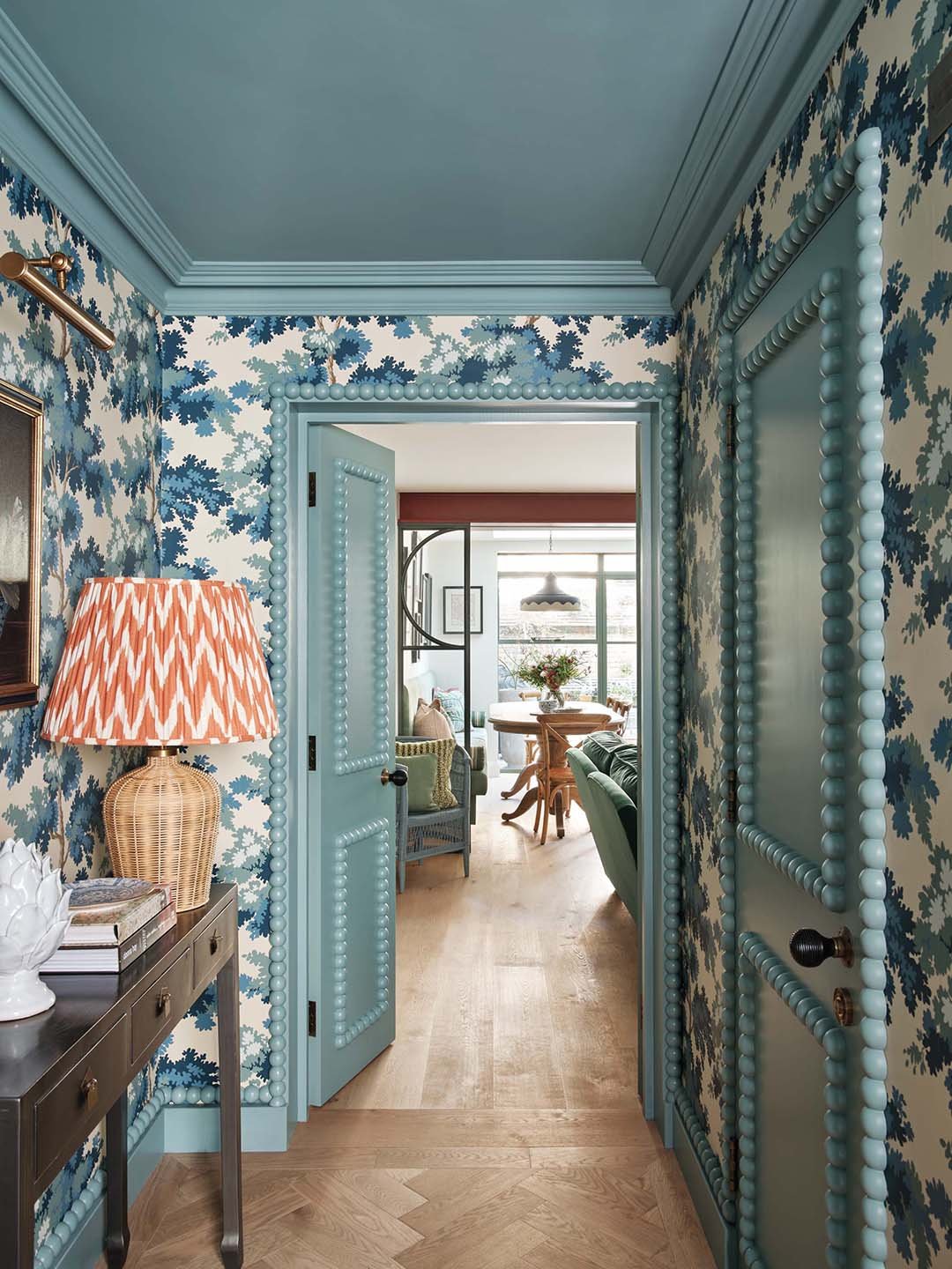 blue wallpapered hallway with bobbin