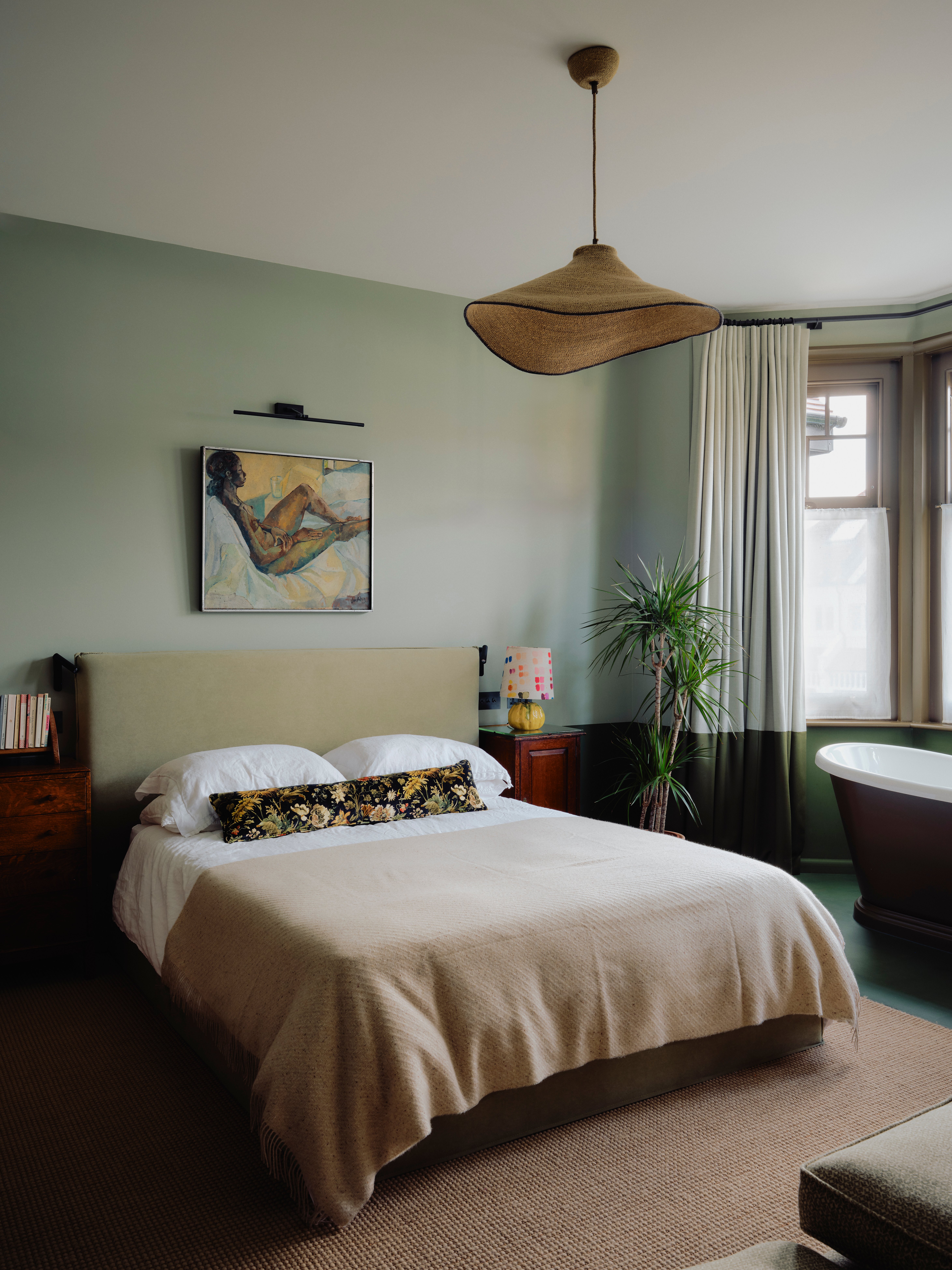 neutral bed with floral bolster pillow