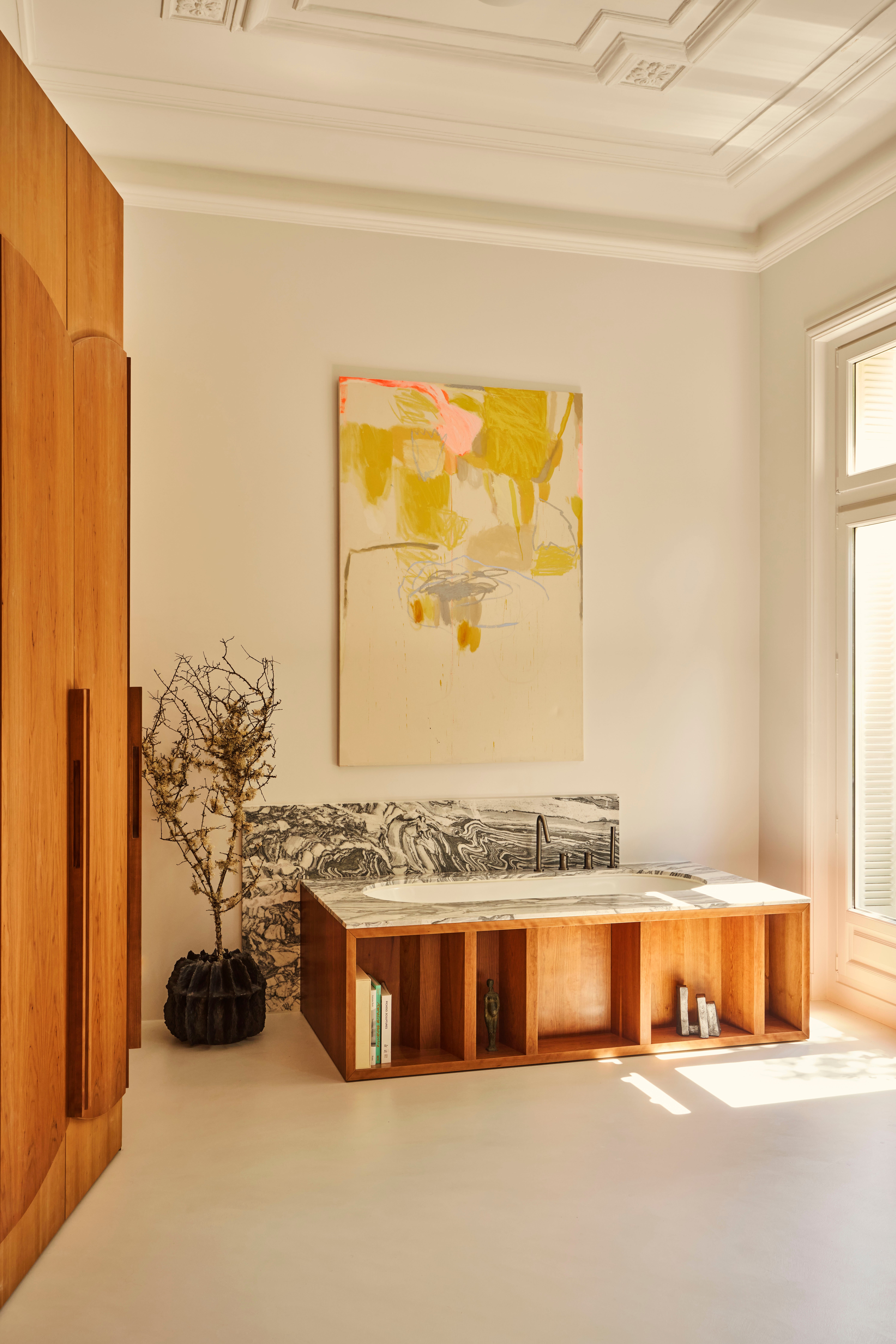 bathtub with bookcase surrounding it