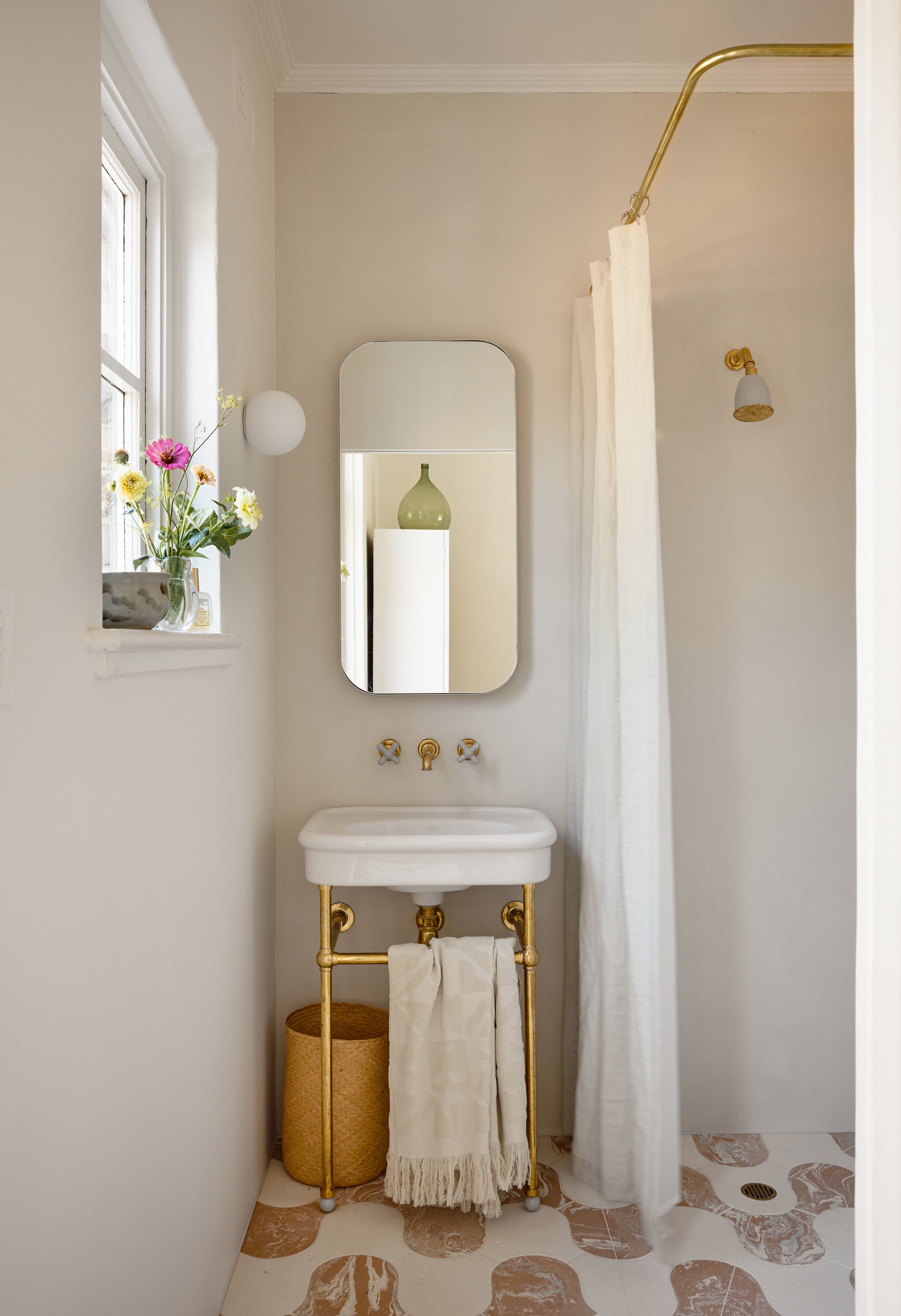white bathroom with graphic tile floor