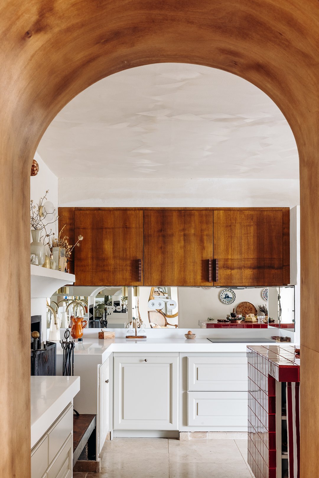 arched doorway leading to a kitchen