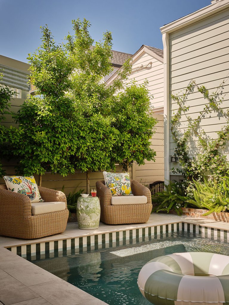 two rattan chairs beside pool