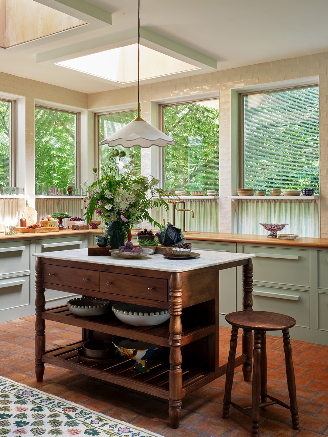 sage green kitchen with wood island