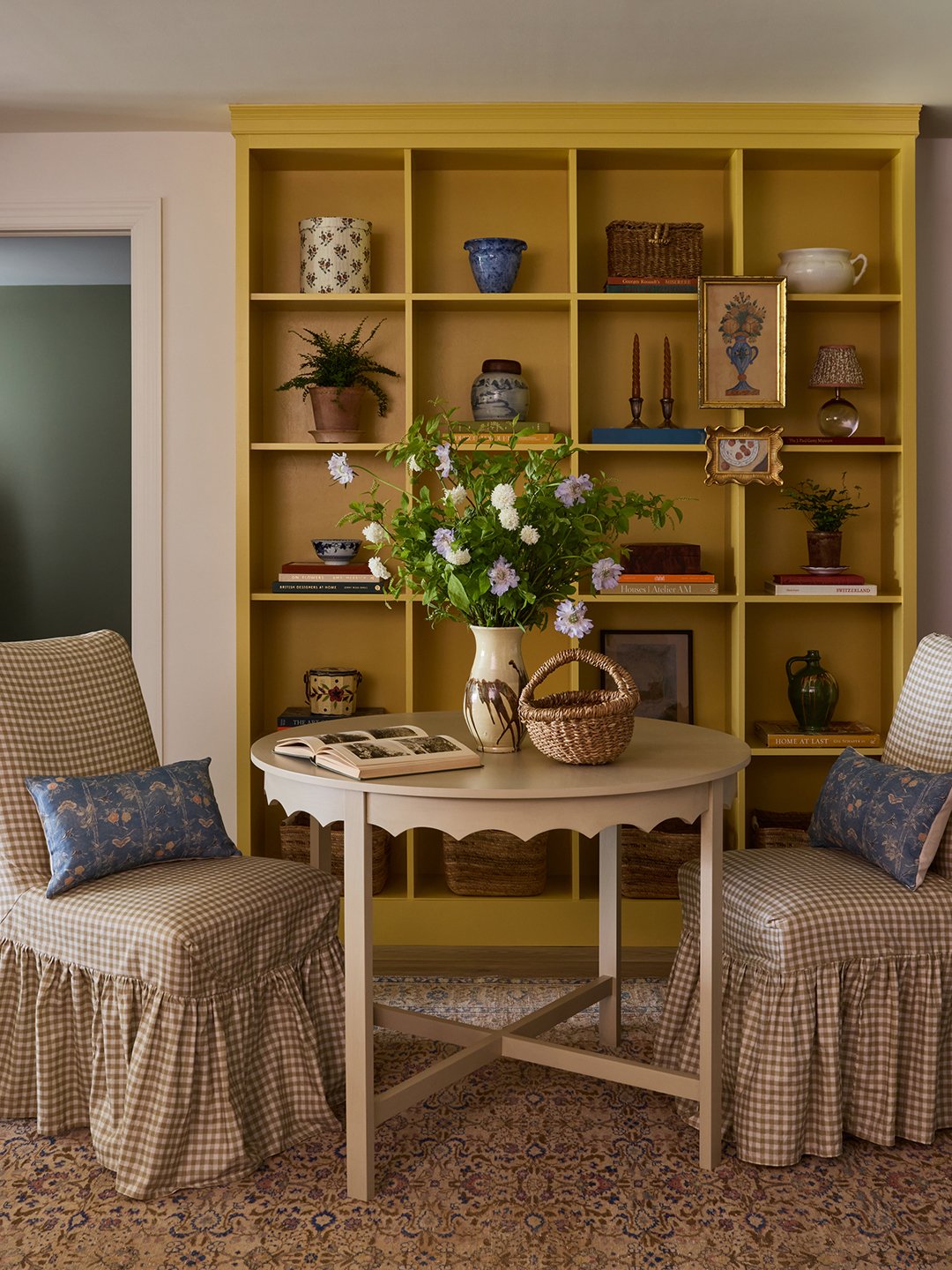 yellow bookshelf and small table with chairs