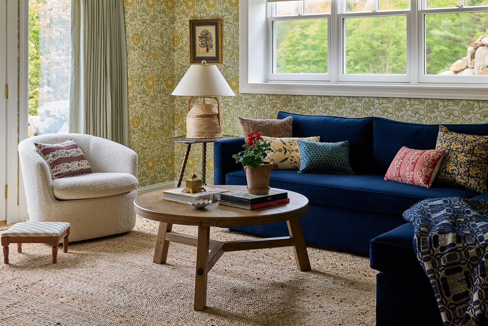 living room with wallpaper and blue sofa