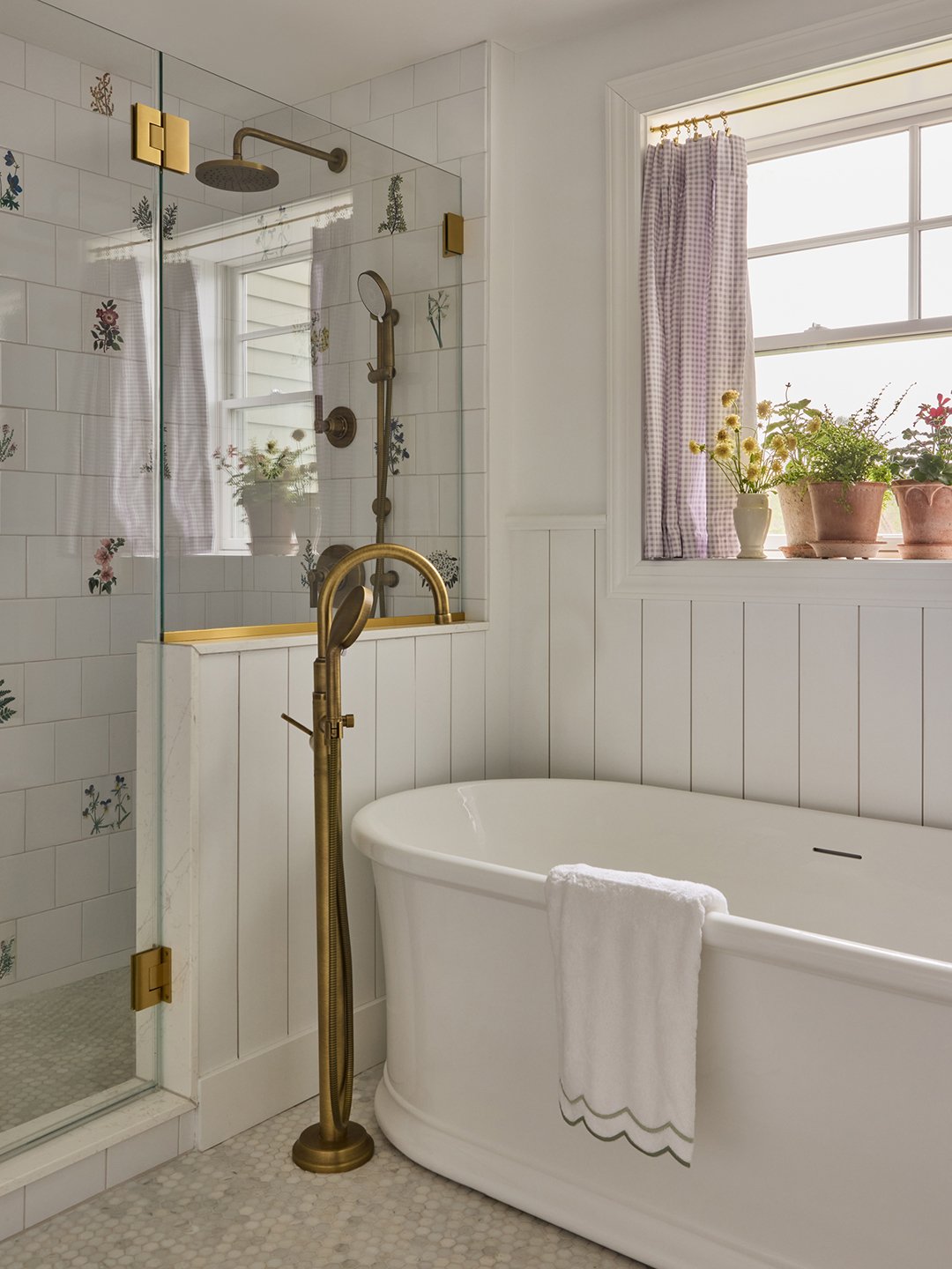 bathroom with soaking tub and botanical tilework