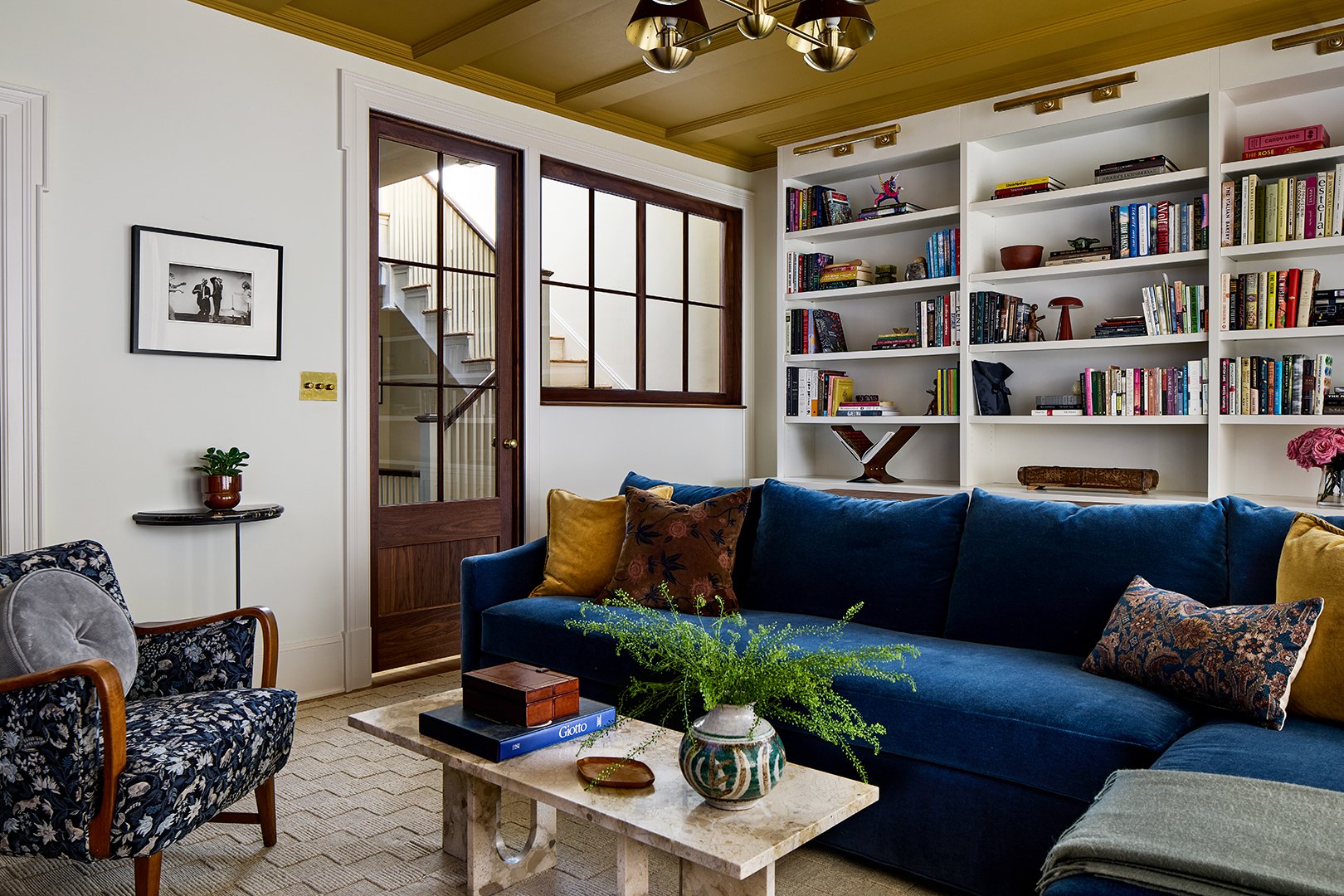 family room with shelves and blue sofa