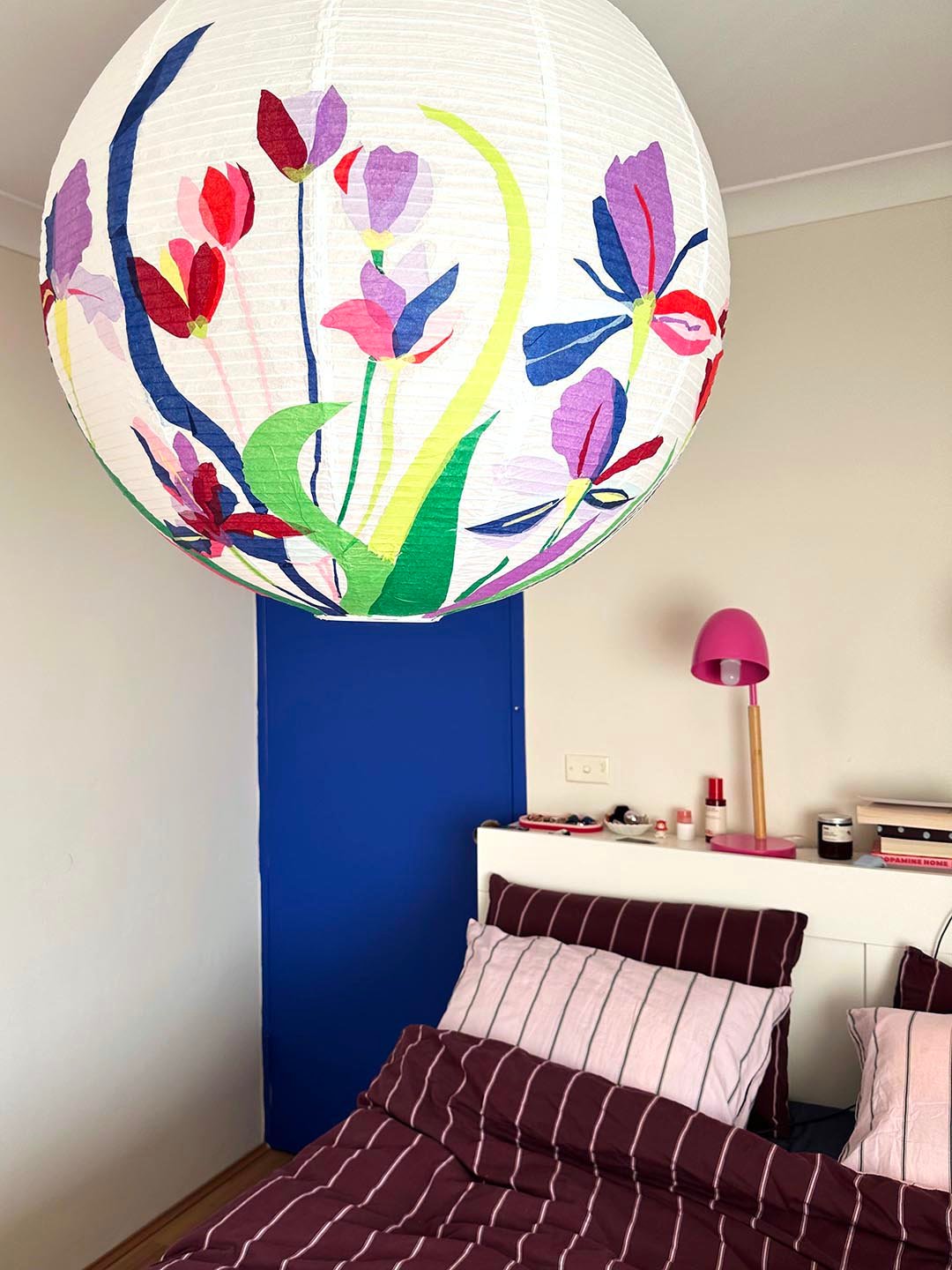 a floral lantern over a bed