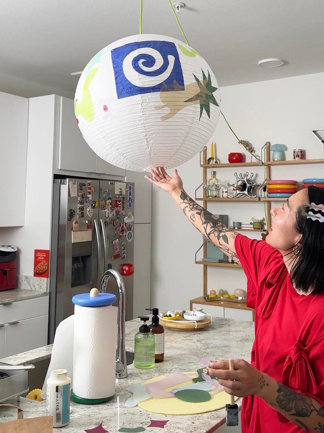 woman admiring paper lantern