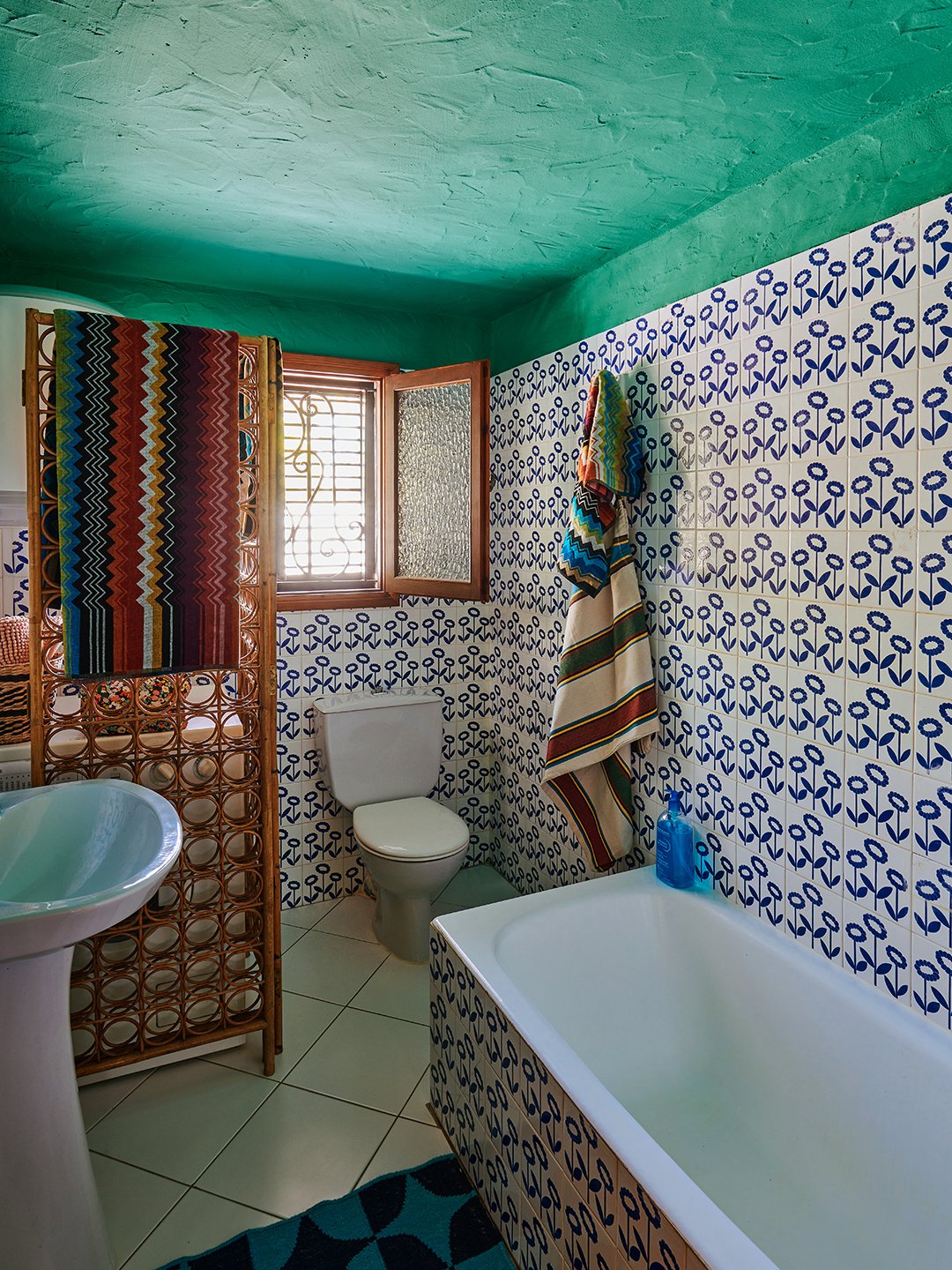 bathroom with blue tile and teal ceiling