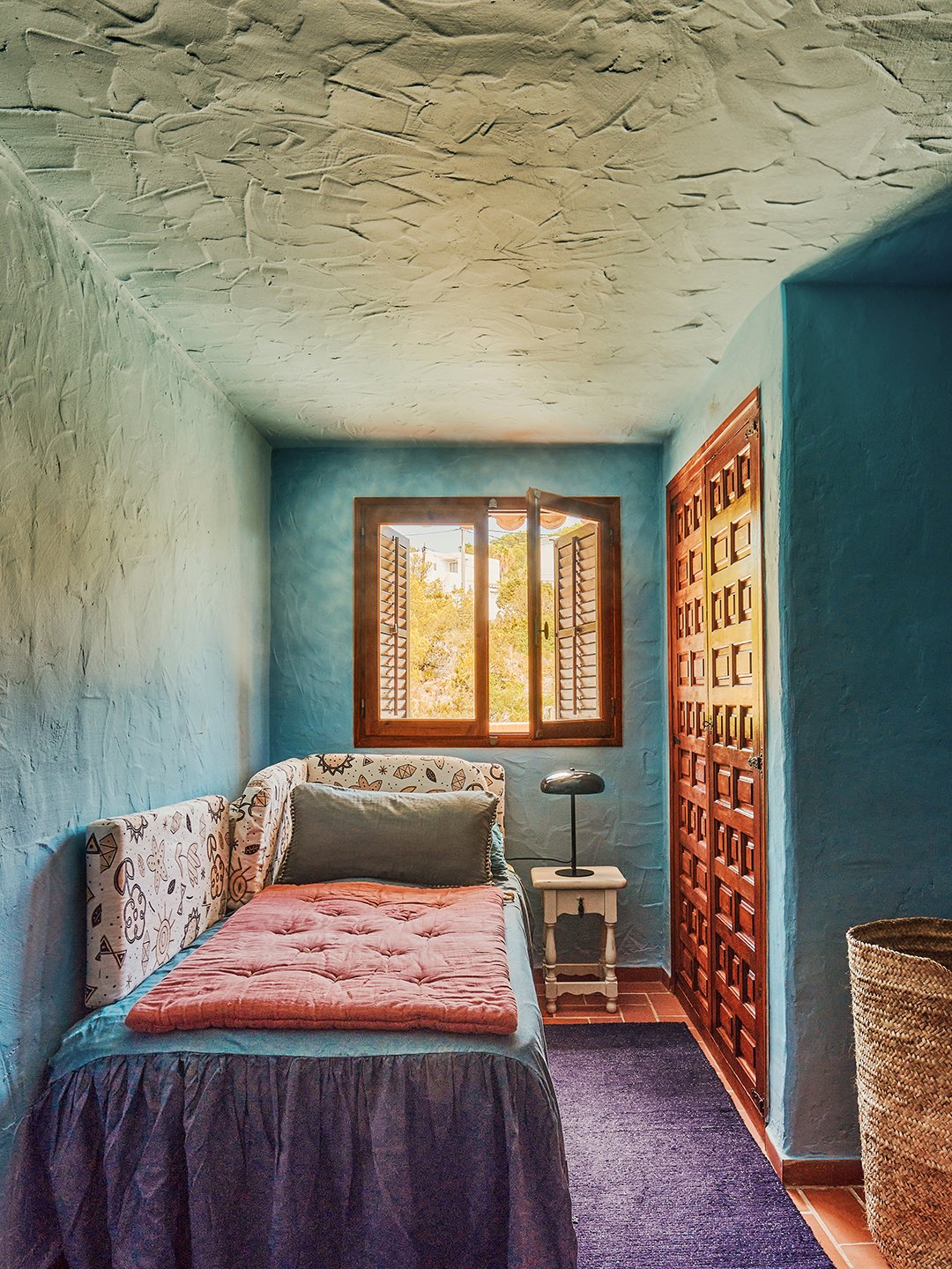 blue bedroom with skirted bed