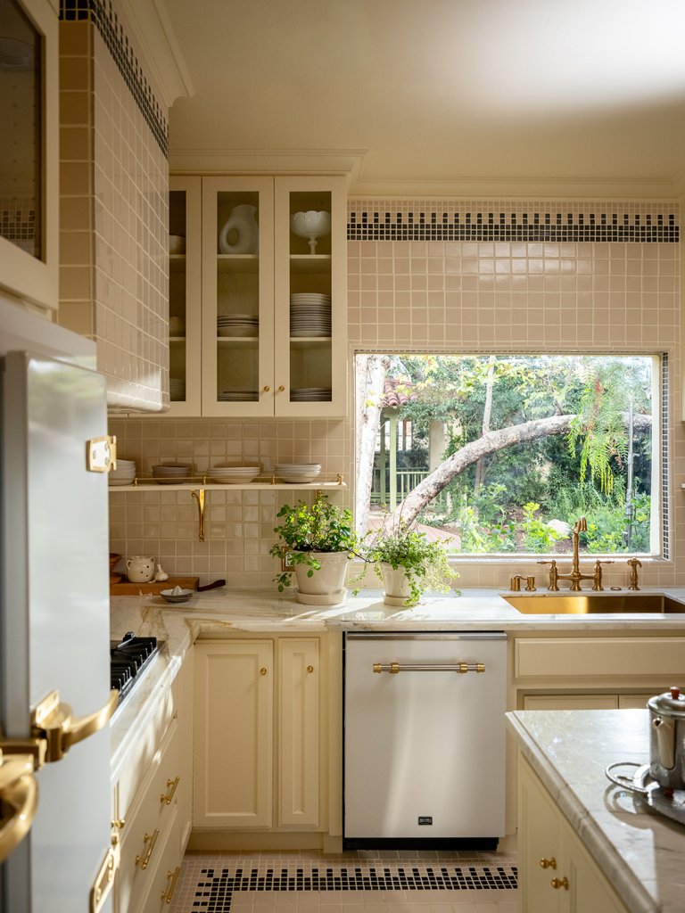 kitchen with cream tiles and cabinets
