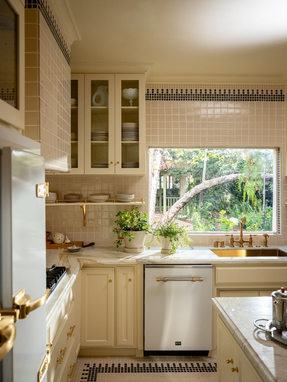 kitchen with cream tiles and cabinets