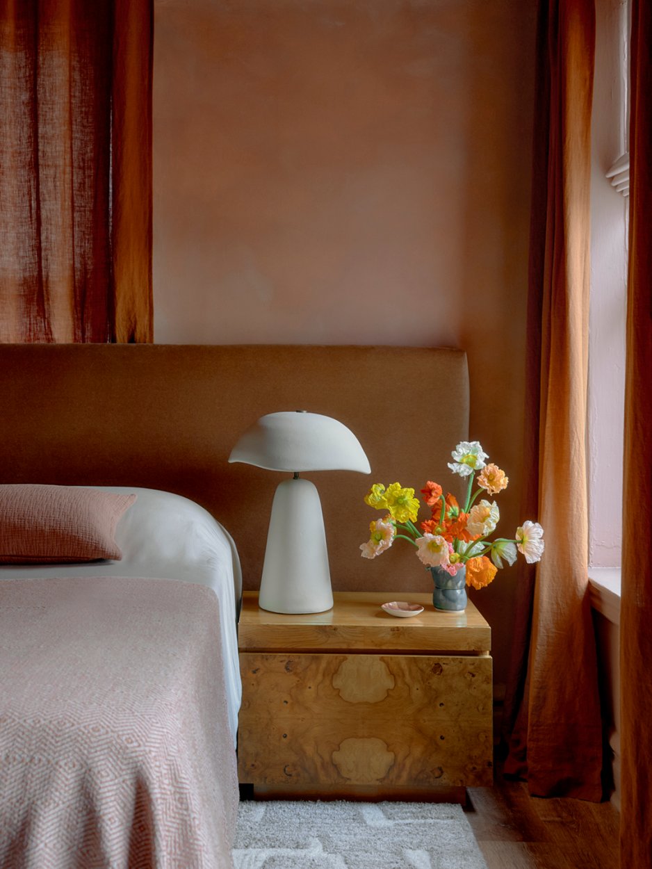 peachy bedroom with burl side table