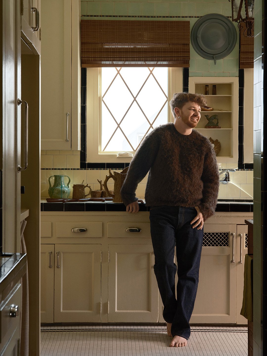 man leaning on kitchen counter