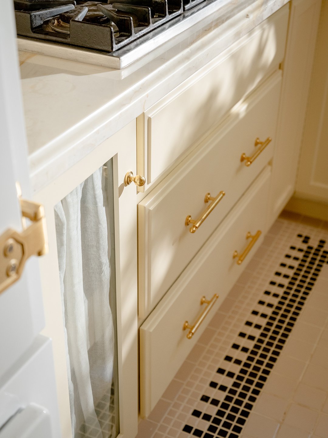 kitchen with cream tiles and cabinets
