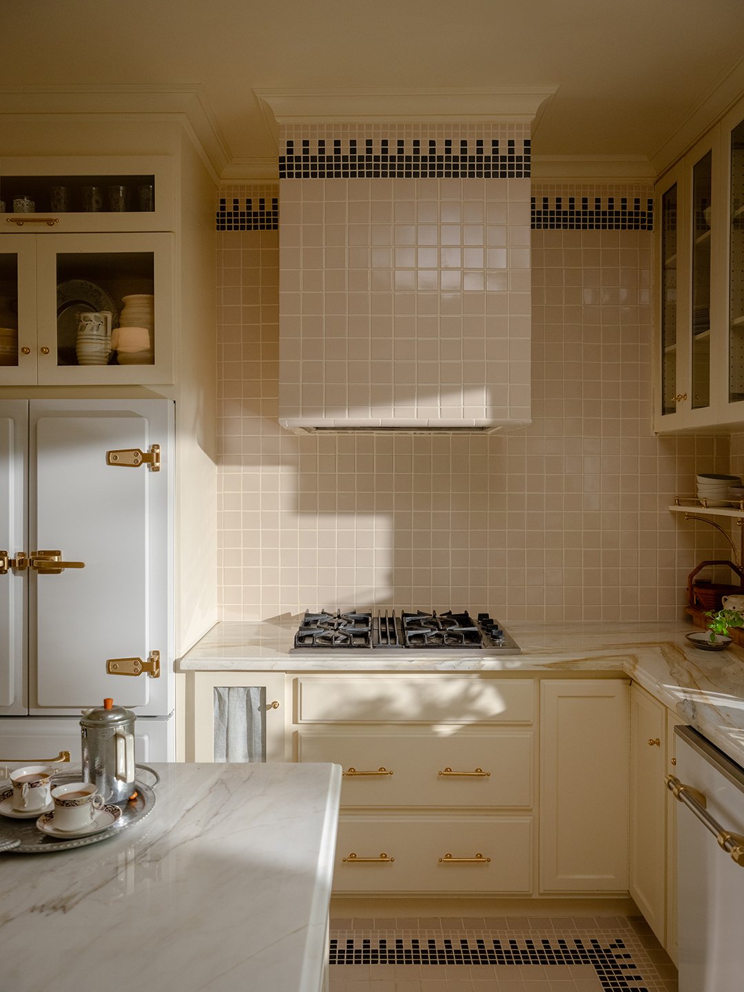 kitchen with cream tiles and cabinets