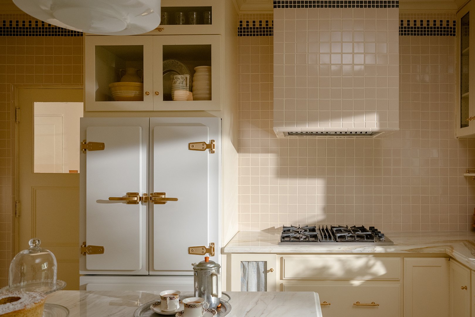 kitchen with cream tiles and cabinets
