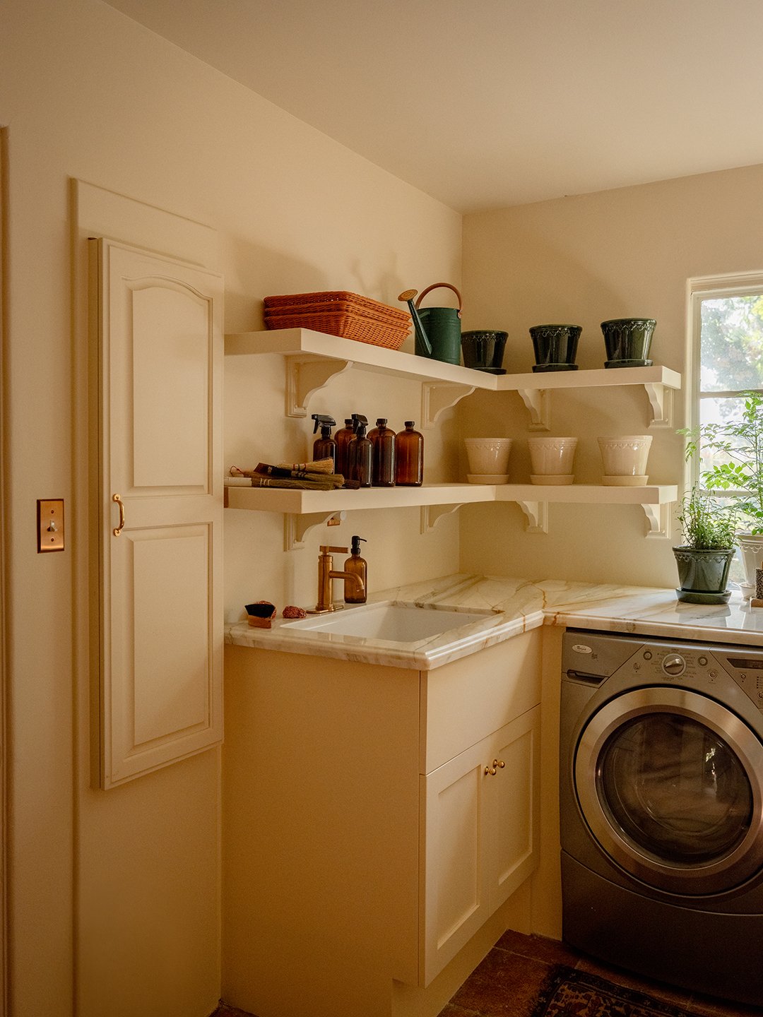 laundry area with cream cabinets
